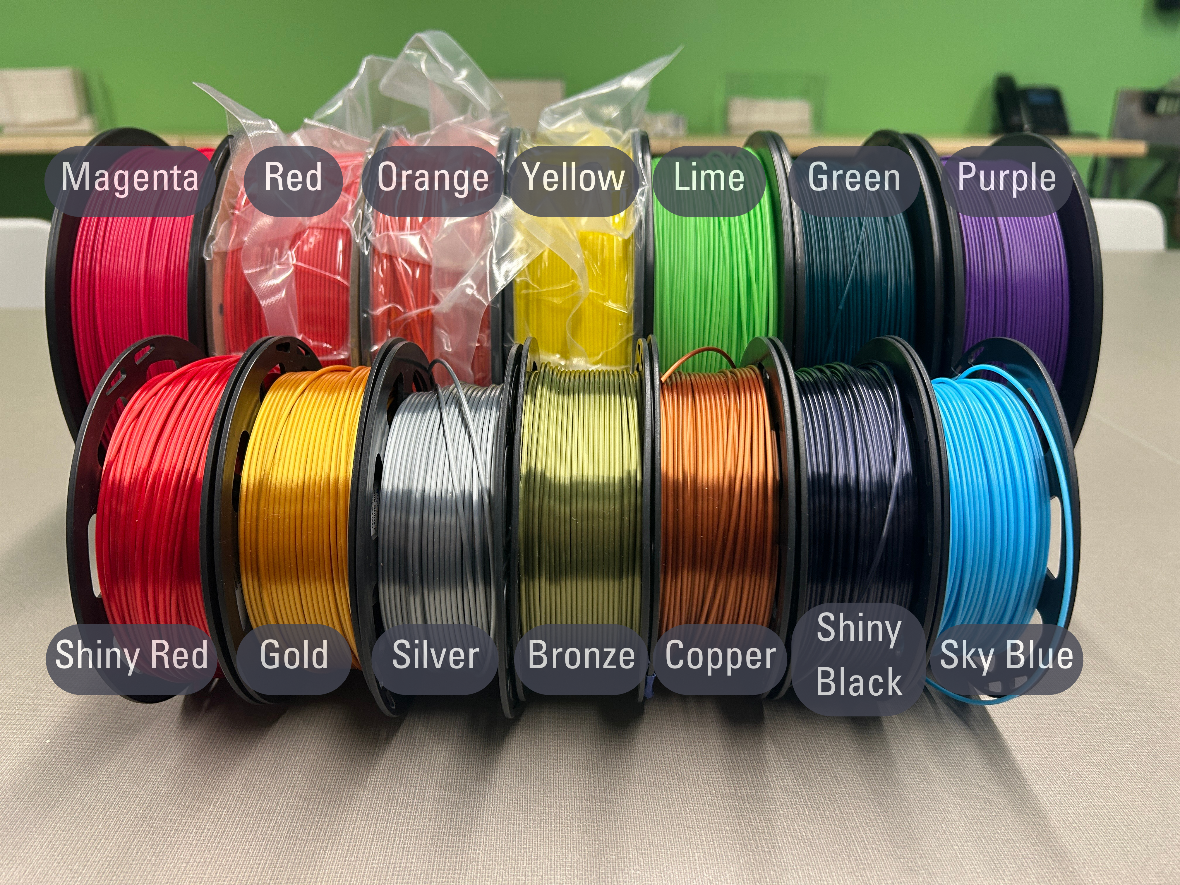 the various spools of different colored PLA filament the makerspace offers