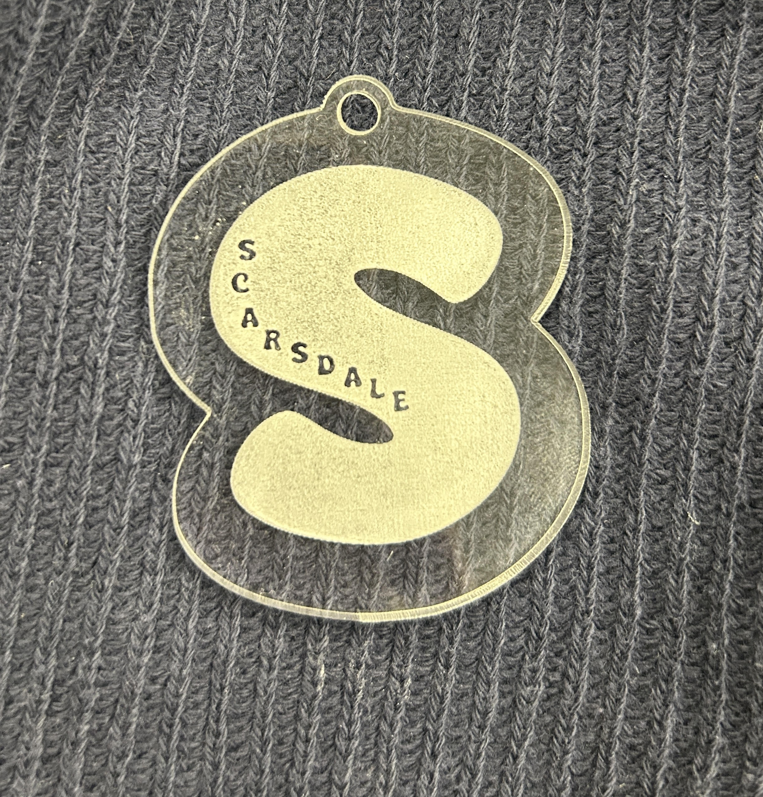 laser cut S shaped acrylic keychain with "SCARSDALE" engraved on it