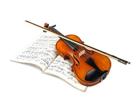 violin on top of music sheets